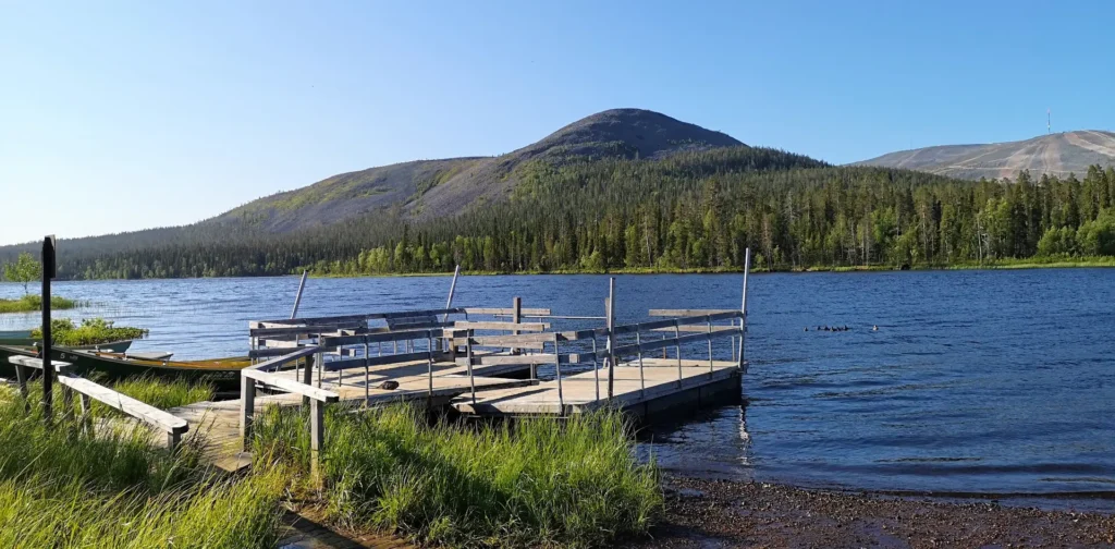 Kesänkijärvi lake with a wooden pier and views of the surrounding fells in Ylläs, Finnish Lapland.