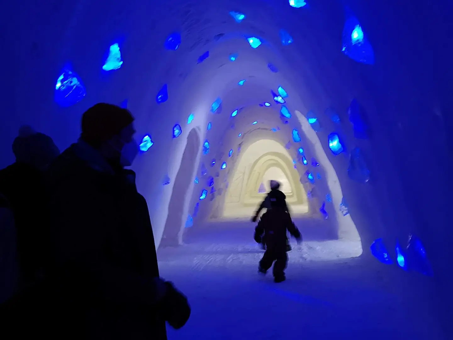 snowcastle2 A child running in a dark ice castle, blue lights on the wall.